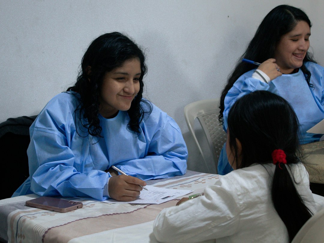 Nursing students in scrubs working through a curriculum document together