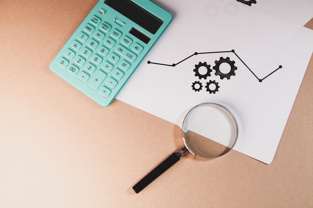 Magnifying glass on desk with documents and chart — representing the systematic evidence review process