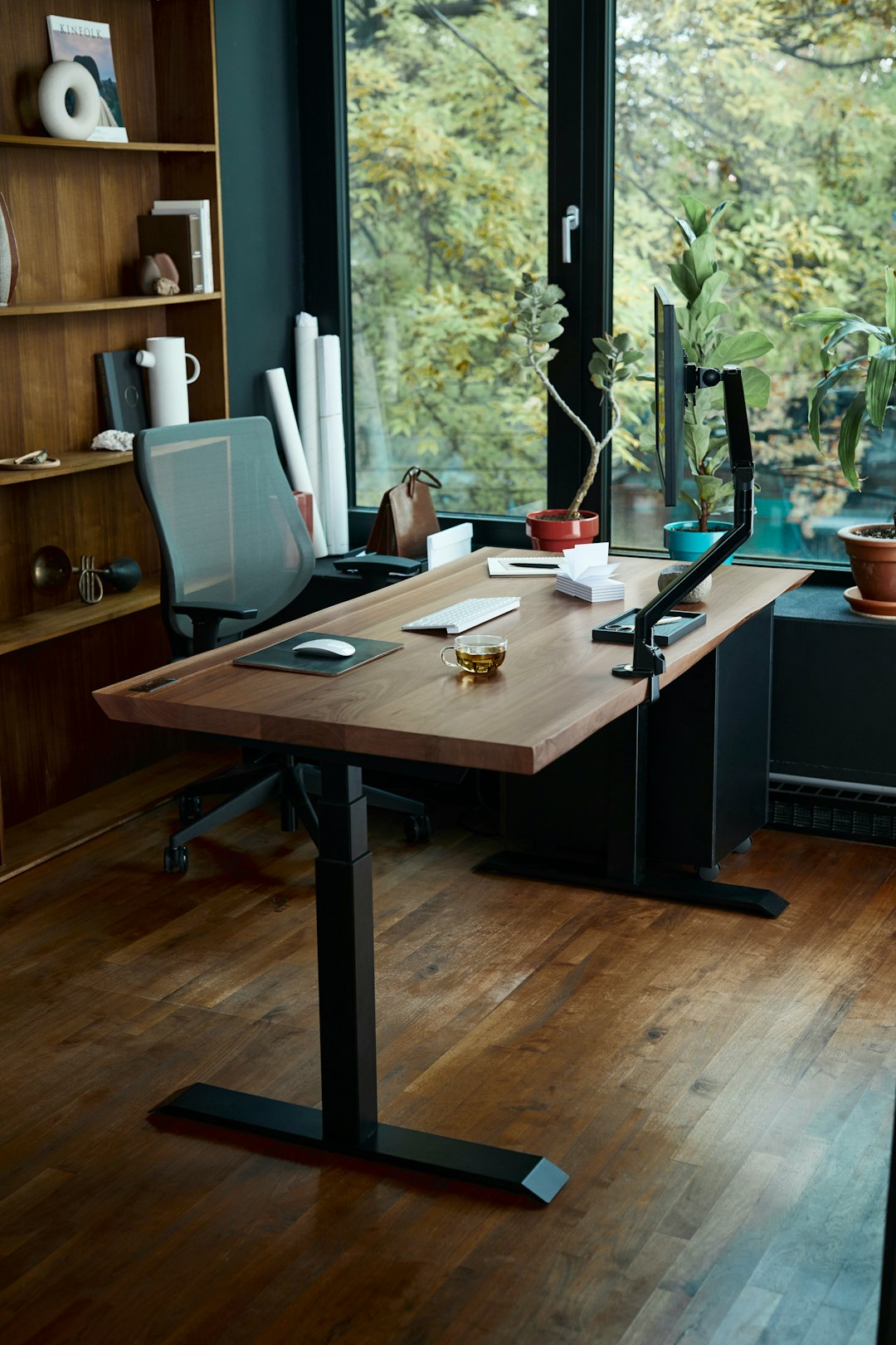 A desk with laptop in front of a window