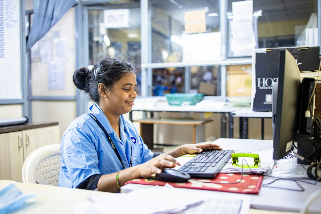 Nurse in scrubs entering data at a computer, representing the annual data collection an SPE prescribes