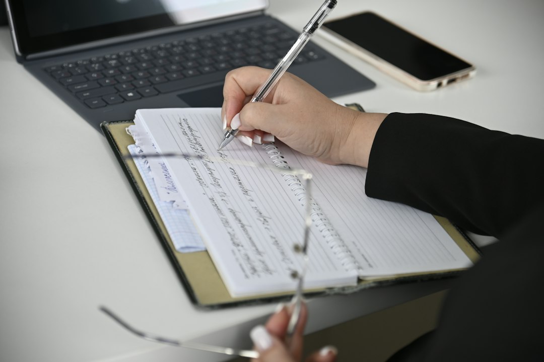 Two people working through an outcomes data form on a laptop together
